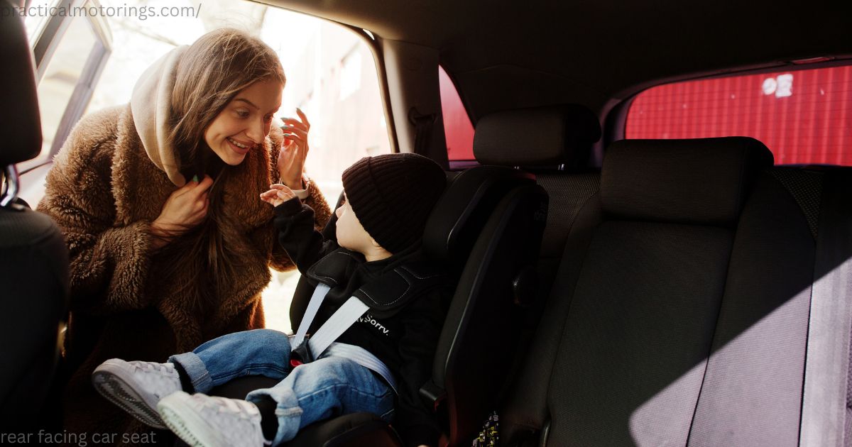 Smiling Canadian parent securely fastening a rear facing car seat with an infant inside a vehicle.