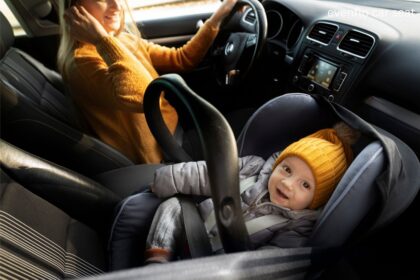 Evenflo car seat installed in the back seat of a car for safe child travel