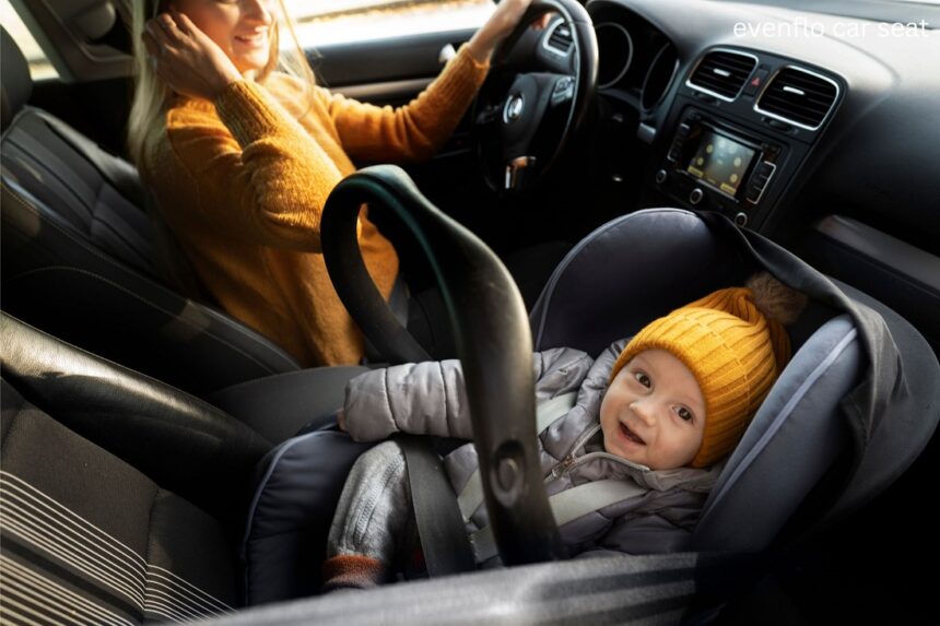 Evenflo car seat installed in the back seat of a car for safe child travel
